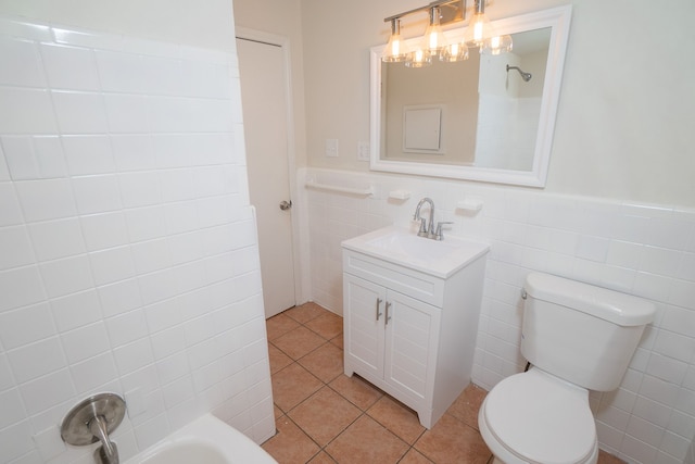 bathroom featuring tile patterned flooring, vanity, toilet, and tile walls