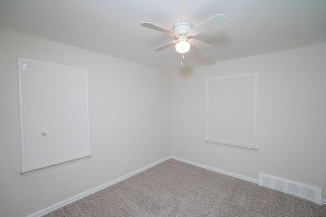 spare room with ceiling fan and carpet floors