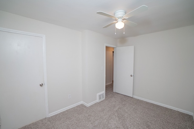 spare room with light carpet and ceiling fan