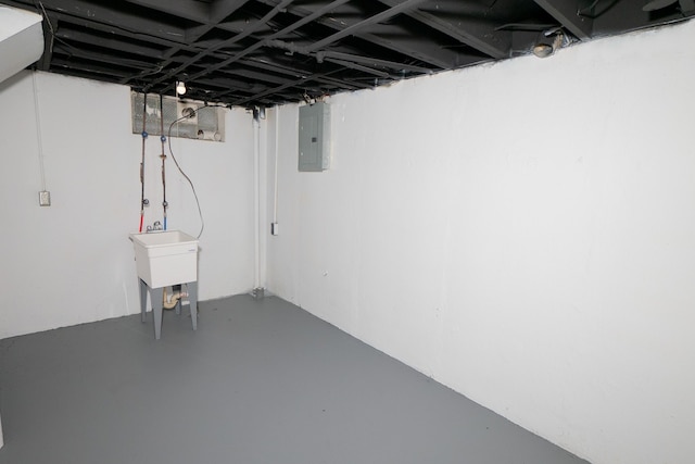 basement with sink and electric panel