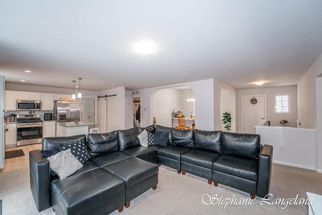 5337 Division Ave N, Comstock Park, MI 49321 - living area featuring arched walkways, light colored carpet, and recessed lighting