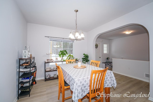 5337 Division Ave N, Comstock Park, MI 49321 - dining space with arched walkways, light wood finished floors, and healthy amount of natural light