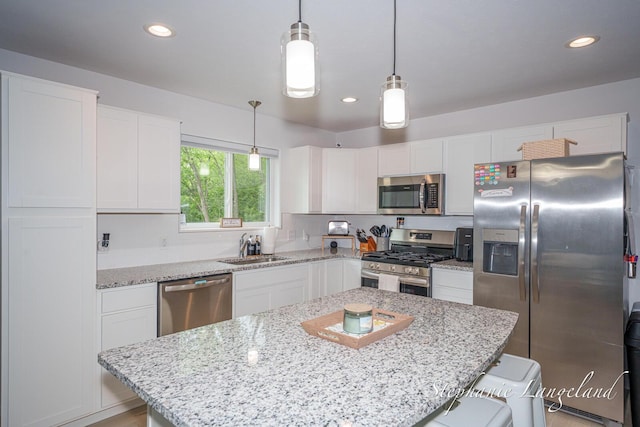 5337 Division Ave N, Comstock Park, MI 49321 - kitchen with appliances with stainless steel finishes, white cabinetry, a sink, and recessed lighting