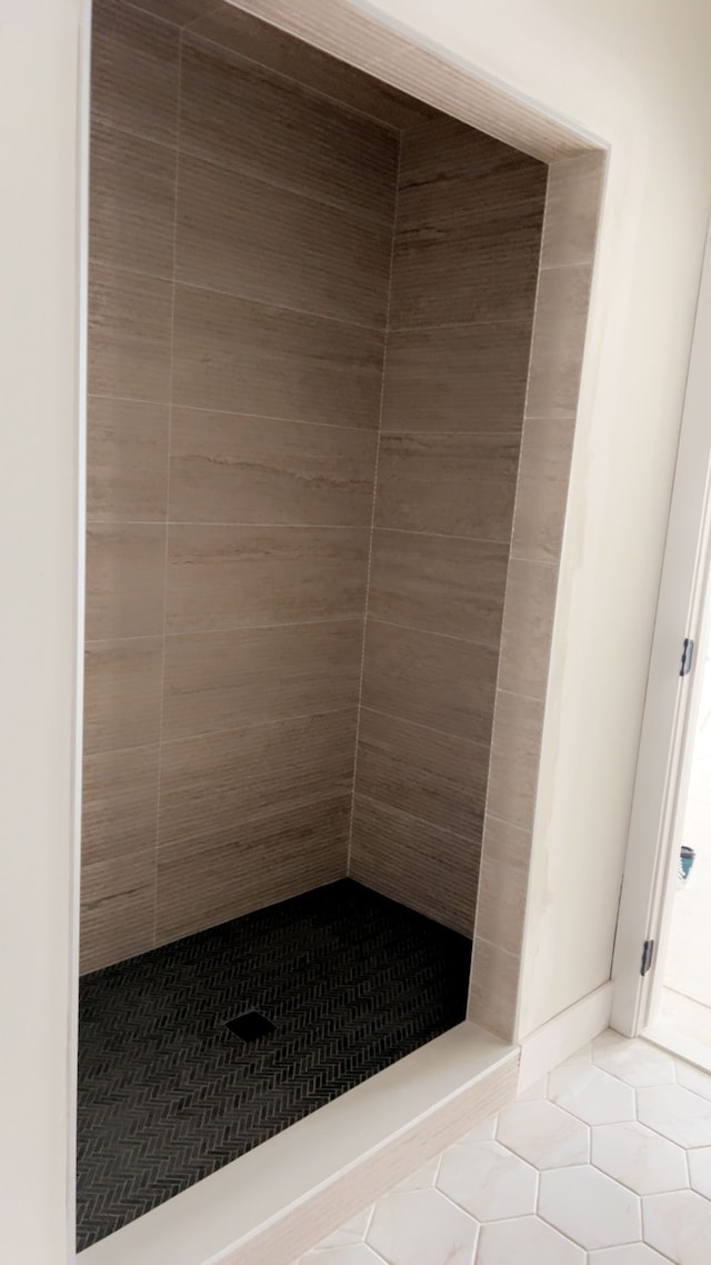 bathroom with tile patterned floors and a shower