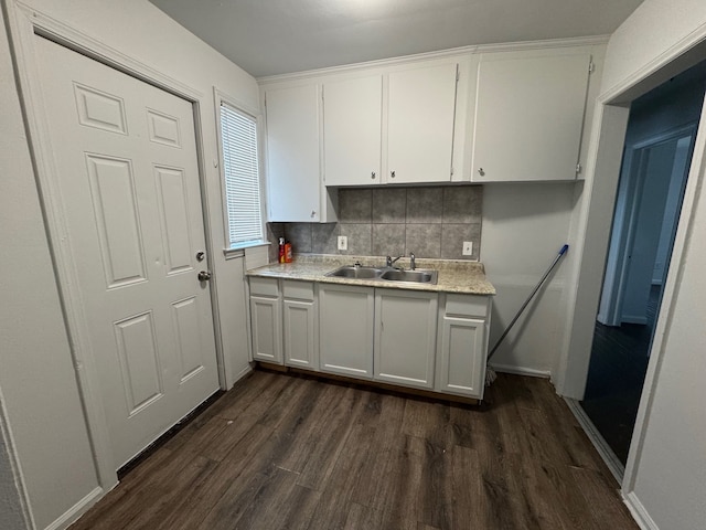 kitchen with backsplash, white cabinetry, sink, and dark hardwood / wood-style floors