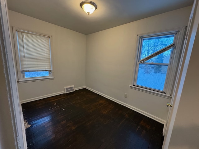 spare room with dark hardwood / wood-style floors