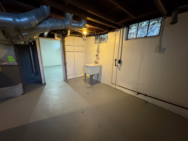 basement with sink and heating unit