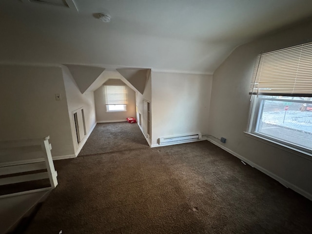 bonus room with dark carpet, baseboard heating, and lofted ceiling