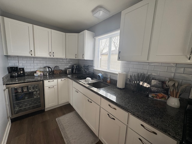 kitchen with white cabinetry, dark hardwood / wood-style floors, sink, and wine cooler