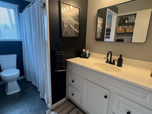 bathroom with vanity, curtained shower, tile patterned floors, and toilet