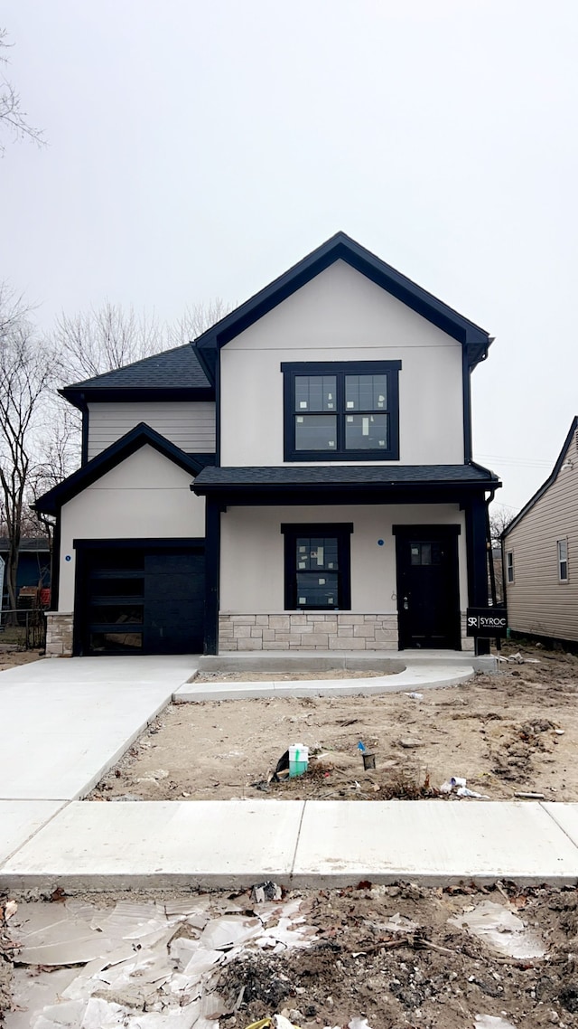 view of front of house with covered porch and a garage