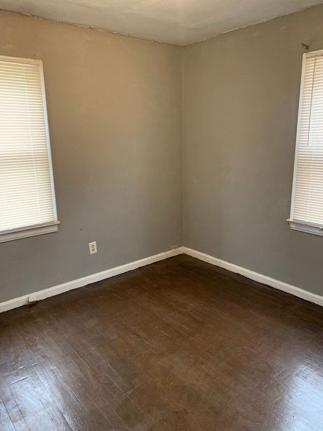 unfurnished room featuring dark hardwood / wood-style flooring