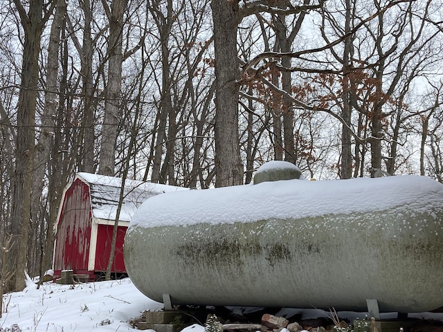 8899 Dwyer Rd, Howell, MI 48855 - snowy yard with a barn and an outbuilding