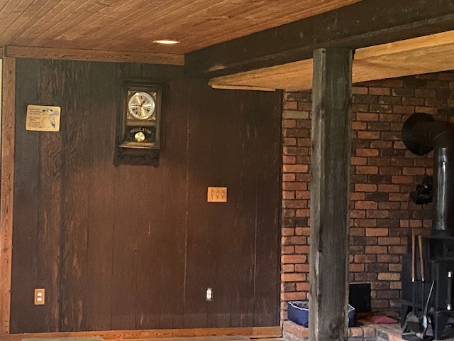 8899 Dwyer Rd, Howell, MI 48855 - detailed view of a wood stove, wooden ceiling, and wooden walls