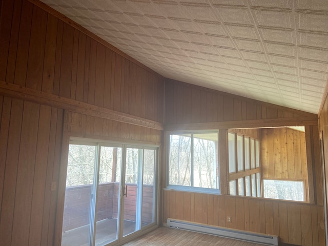 8899 Dwyer Rd, Howell, MI 48855 - unfurnished sunroom featuring a baseboard radiator and vaulted ceiling