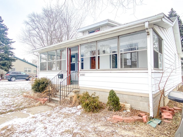 view of front of home featuring a sunroom