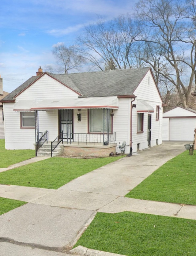 ranch-style house with covered porch, a garage, a front lawn, and an outdoor structure