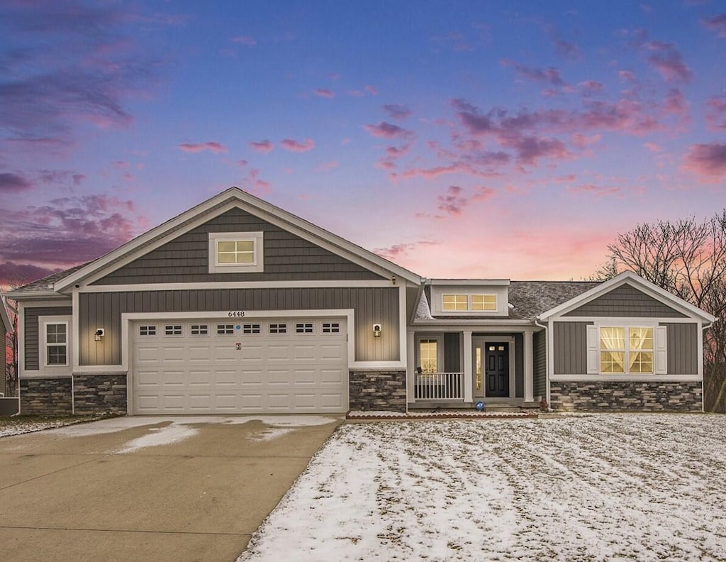 view of front of property with a porch and a garage