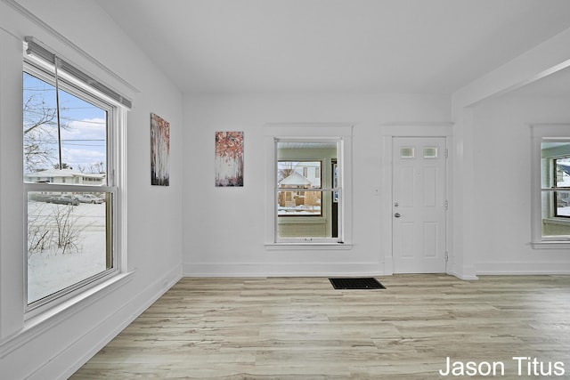 entryway with light hardwood / wood-style floors