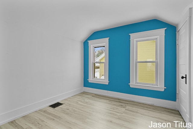 bonus room featuring lofted ceiling and light hardwood / wood-style flooring