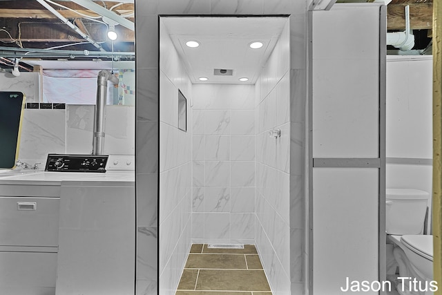 bathroom with tile patterned floors, washer / clothes dryer, vanity, and toilet