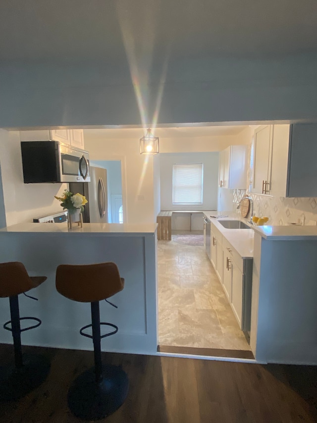 kitchen featuring sink, white cabinets, and stainless steel appliances