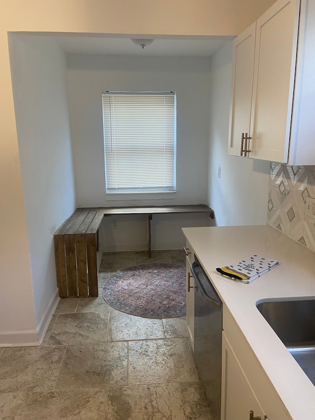 kitchen with dishwasher and white cabinetry