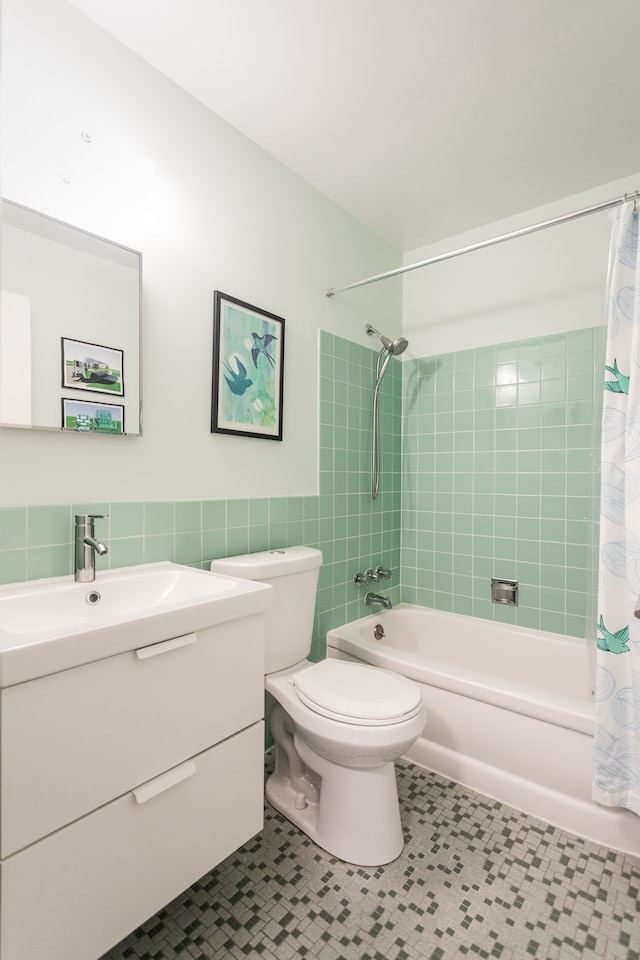 full bathroom featuring shower / tub combo, vanity, tile walls, tile patterned flooring, and toilet