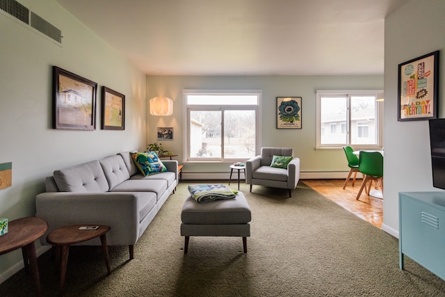 living room featuring carpet flooring and a baseboard heating unit