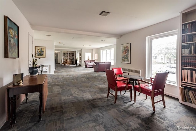 dining space featuring dark colored carpet