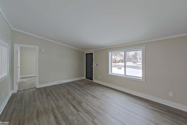 spare room with dark hardwood / wood-style floors and crown molding