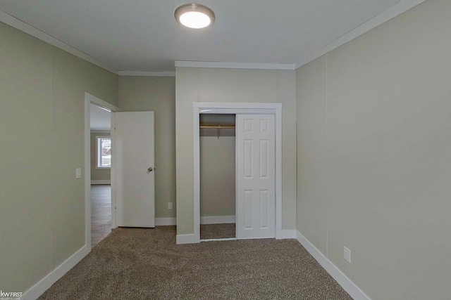 unfurnished bedroom with carpet flooring, a closet, and ornamental molding