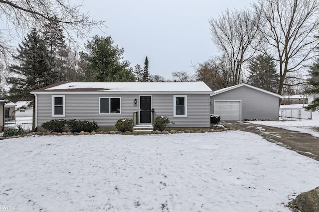 view of front of home with a garage and an outbuilding