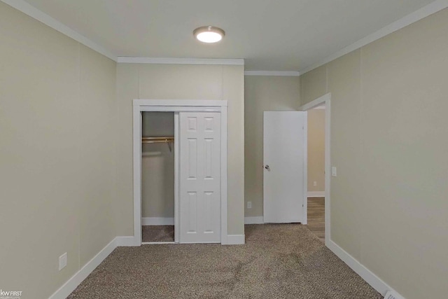 unfurnished bedroom featuring carpet floors, a closet, and ornamental molding