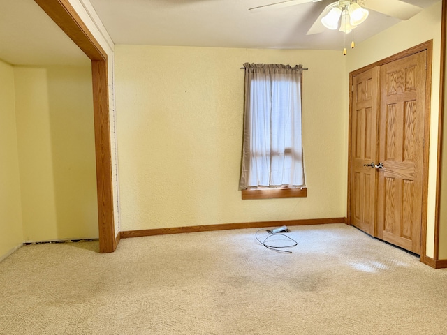 unfurnished room with ceiling fan and light colored carpet