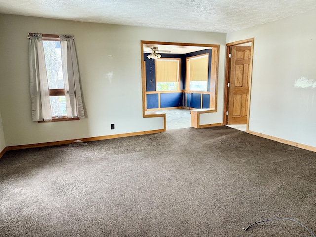 empty room featuring carpet, a textured ceiling, and ceiling fan