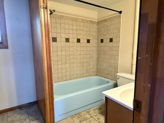 full bathroom with tile patterned flooring, vanity, toilet, and tiled shower / bath