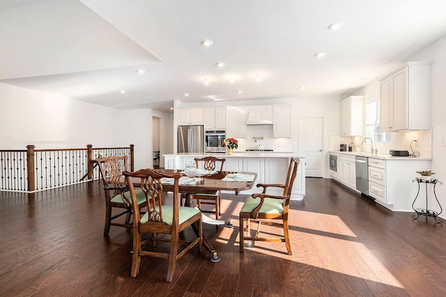 dining space featuring dark hardwood / wood-style floors and sink