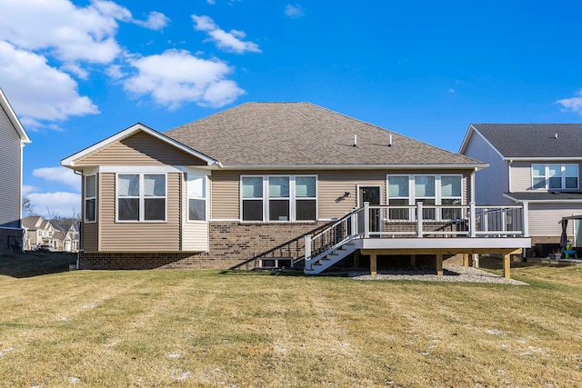 rear view of property featuring a wooden deck and a yard