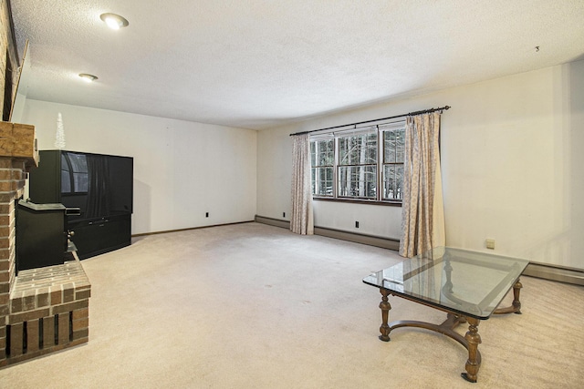 living area featuring carpet, a baseboard heating unit, a fireplace, and a textured ceiling