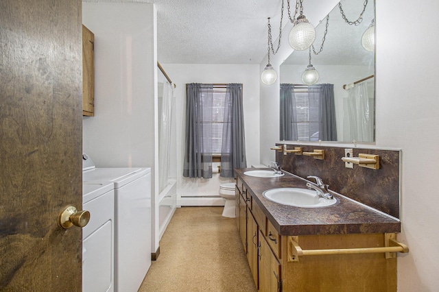 full bathroom featuring washing machine and clothes dryer, baseboard heating, backsplash, a textured ceiling, and vanity