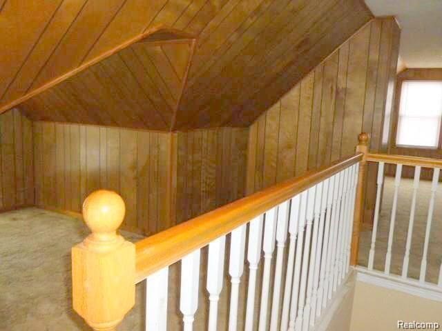 interior space featuring wood walls and wooden ceiling