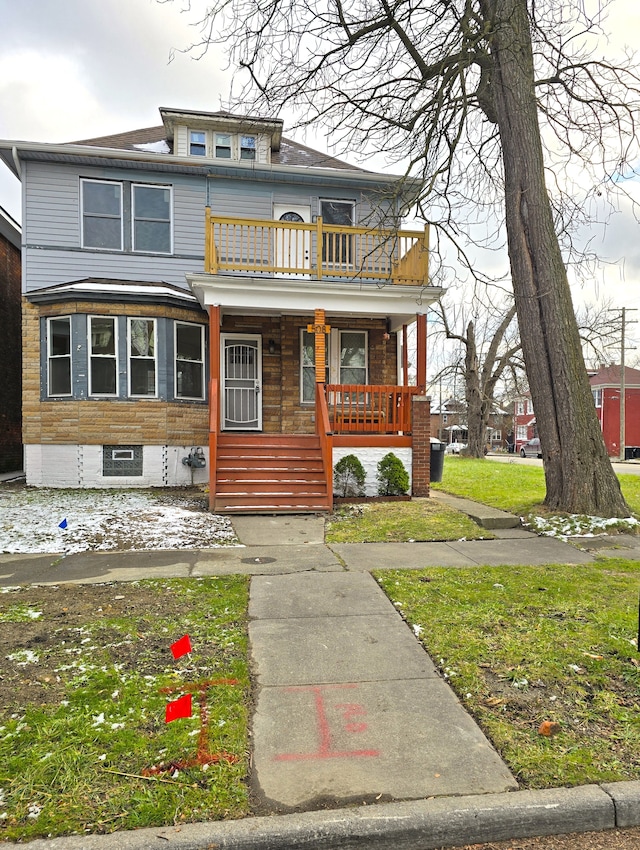 view of front of property featuring covered porch and a balcony