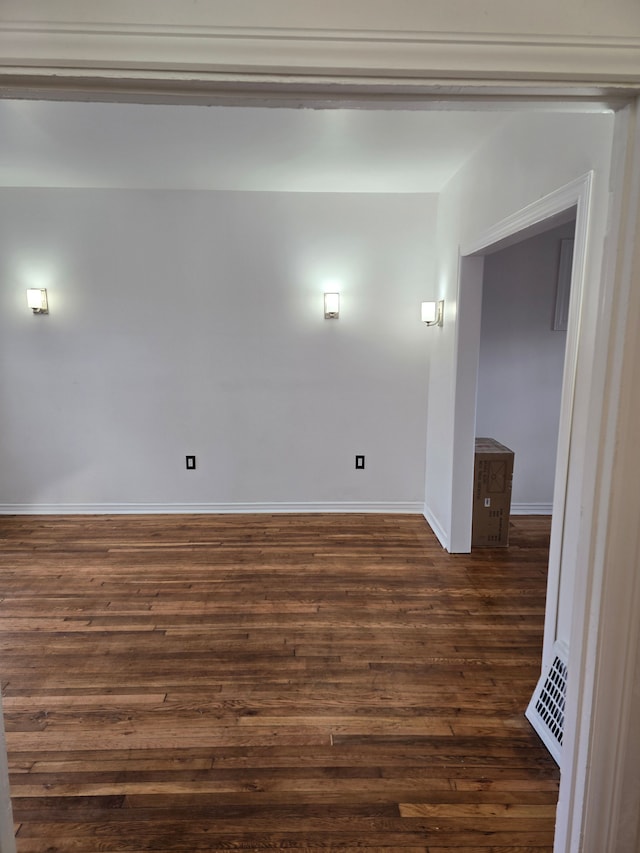 spare room featuring dark hardwood / wood-style flooring