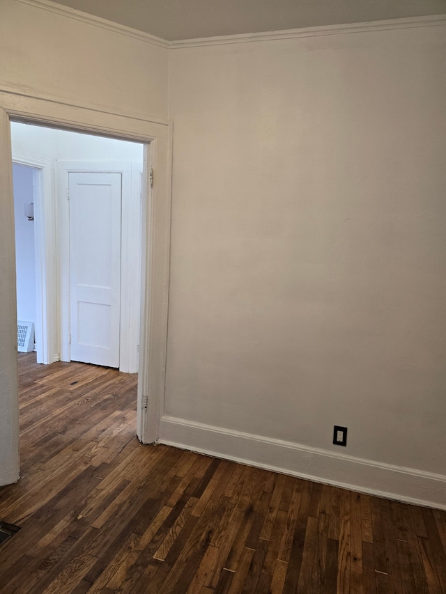 unfurnished room with crown molding and dark hardwood / wood-style floors