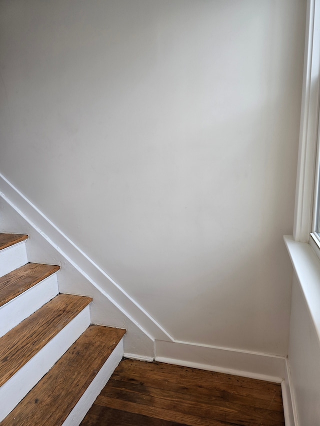 stairs featuring wood-type flooring