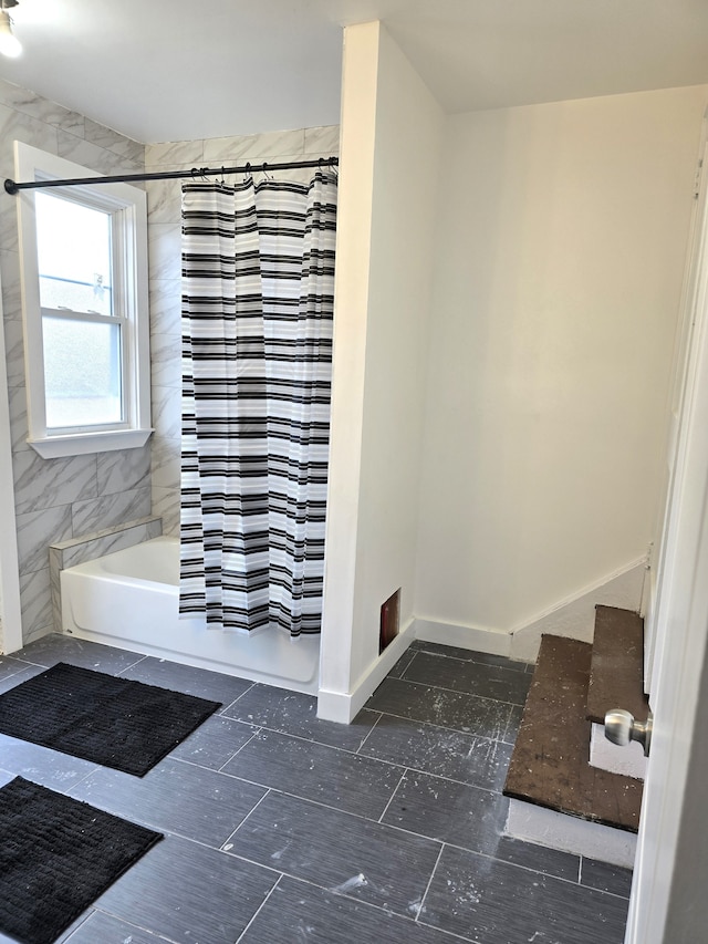 bathroom with shower / bathtub combination with curtain