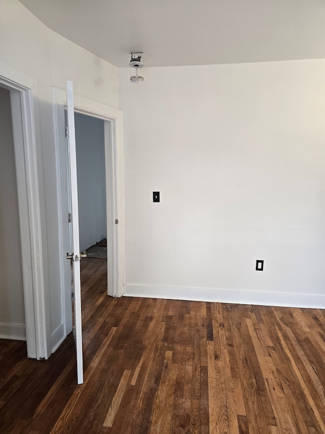 unfurnished room featuring dark hardwood / wood-style flooring