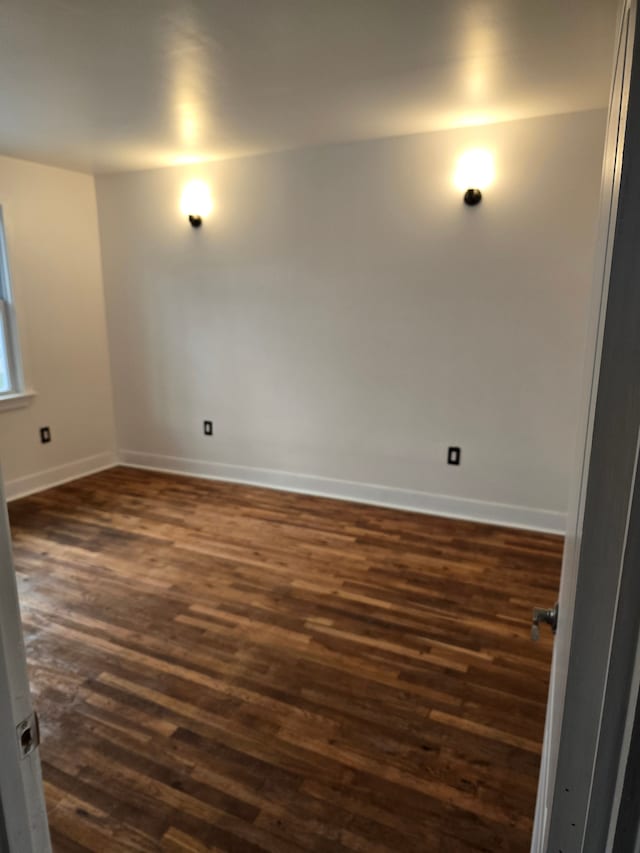 spare room featuring dark hardwood / wood-style floors