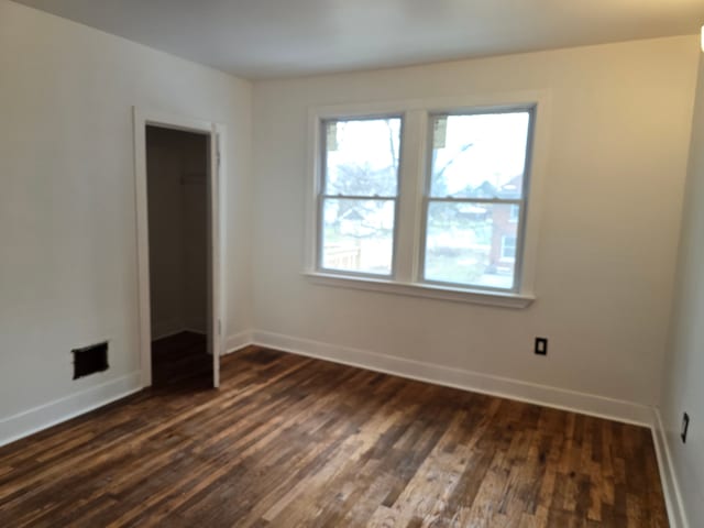 empty room featuring dark hardwood / wood-style flooring